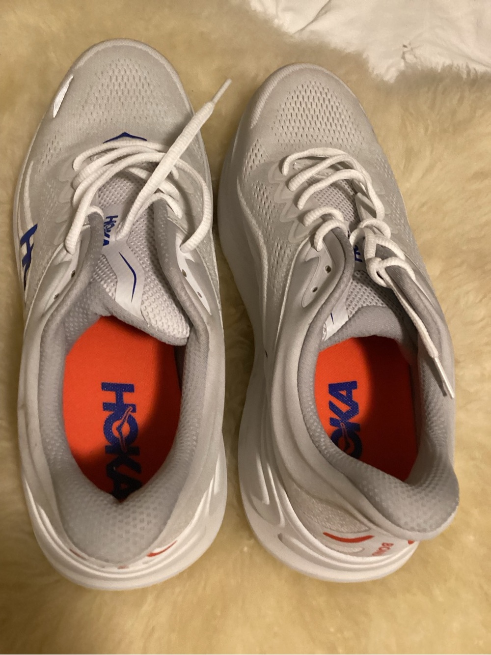 Hoka Men’s White Athletic Shoes with Orange Insoles and Blue Logo